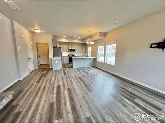 a view of kitchen and wooden floor