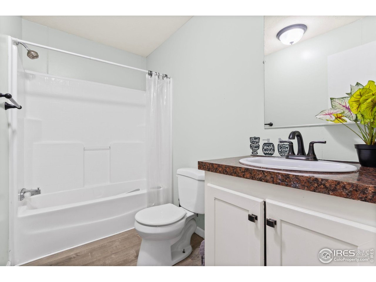 2500 East Harmony Road, Unit 105 Fort Collins, CO 80528 - Photo 12 of 21 a bathroom with a sink a toilet and shower