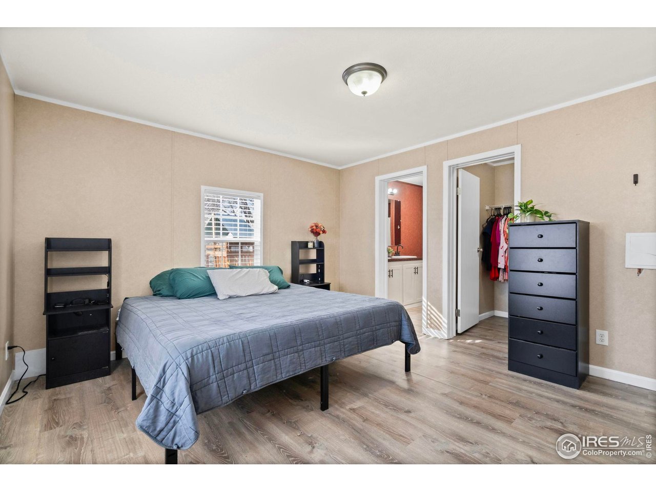 2500 East Harmony Road, Unit 105 Fort Collins, CO 80528 - Photo 14 of 21 a bedroom with a bed and a closet