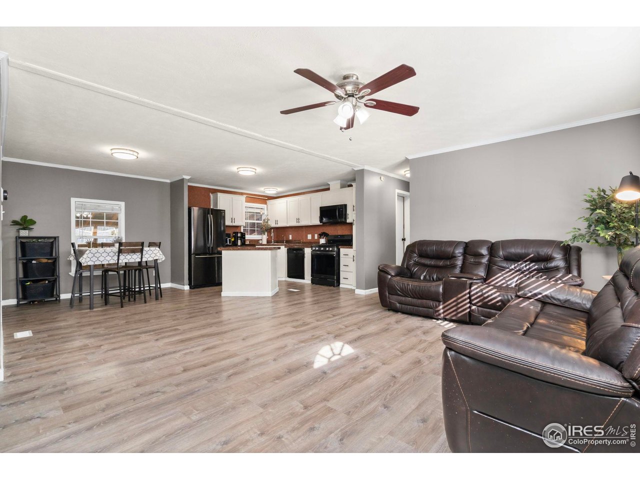2500 East Harmony Road, Unit 105 Fort Collins, CO 80528 - Photo 21 of 21 a living room with furniture and kitchen view with wooden floor