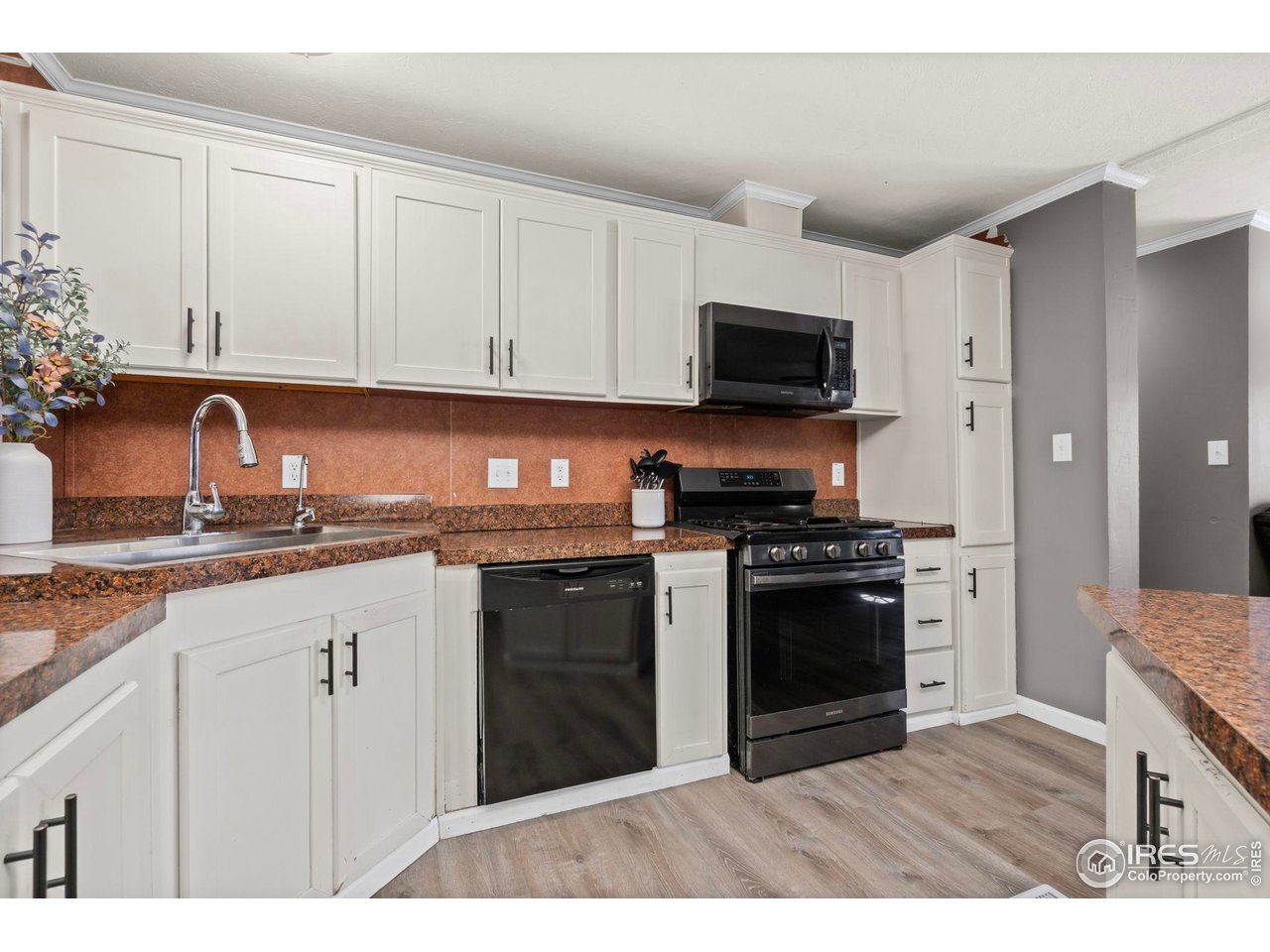 2500 East Harmony Road, Unit 105 Fort Collins, CO 80528 - Photo 9 of 21 a kitchen with stainless steel appliances granite countertop a stove top oven a sink and dishwasher