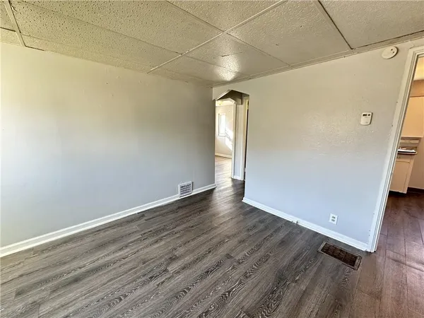 a view of a room with wooden floor and white walls