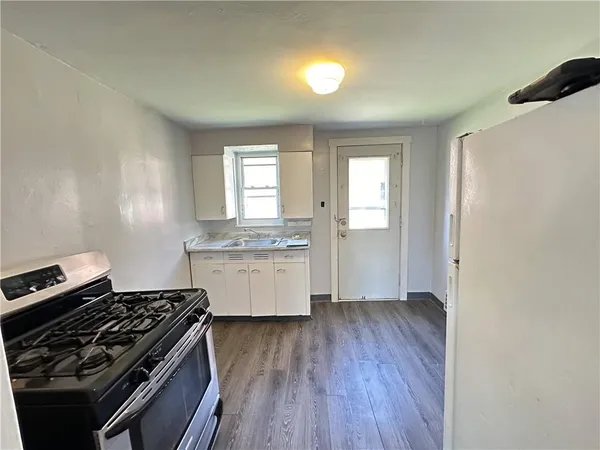 a kitchen with granite countertop a stove and a refrigerator