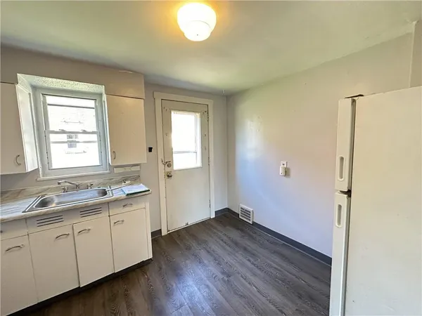 a view of a kitchen with wooden floor