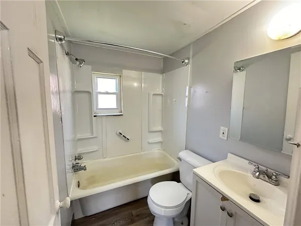 a bathroom with a sink mirror toilet and bathtub