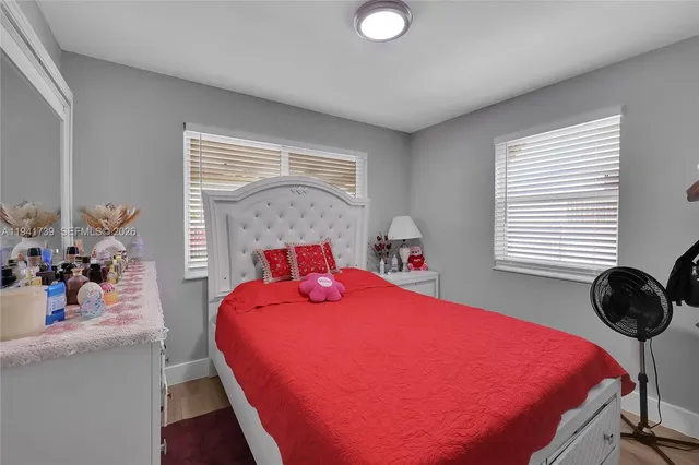 a bedroom with a bed and window