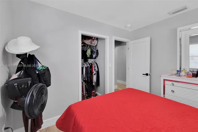 a bed room with a bed and a mirror