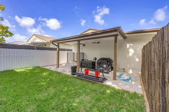 a backyard view with a seating space