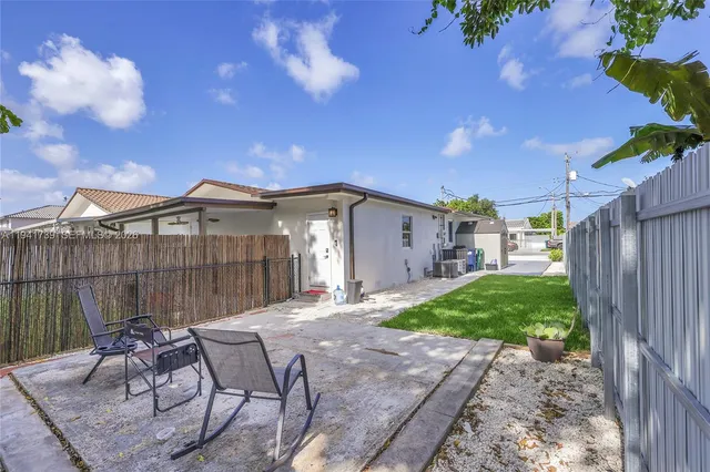 a view of a backyard with furniture and a backyard