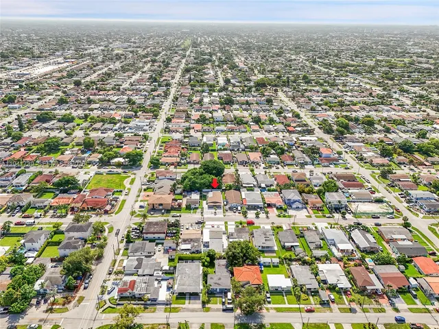 an aerial view of residential houses with city view