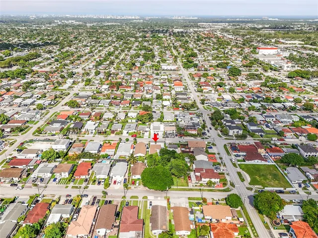 an aerial view of residential houses with outdoor space and swimming pool