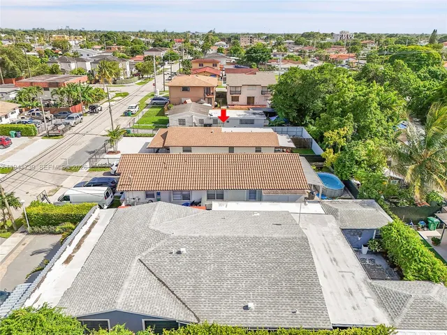 an aerial view of residential houses with outdoor space