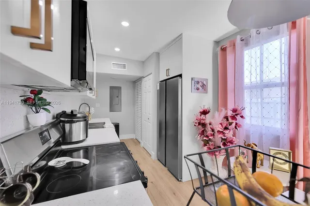 a kitchen with stainless steel appliances granite countertop a refrigerator and a stove top oven