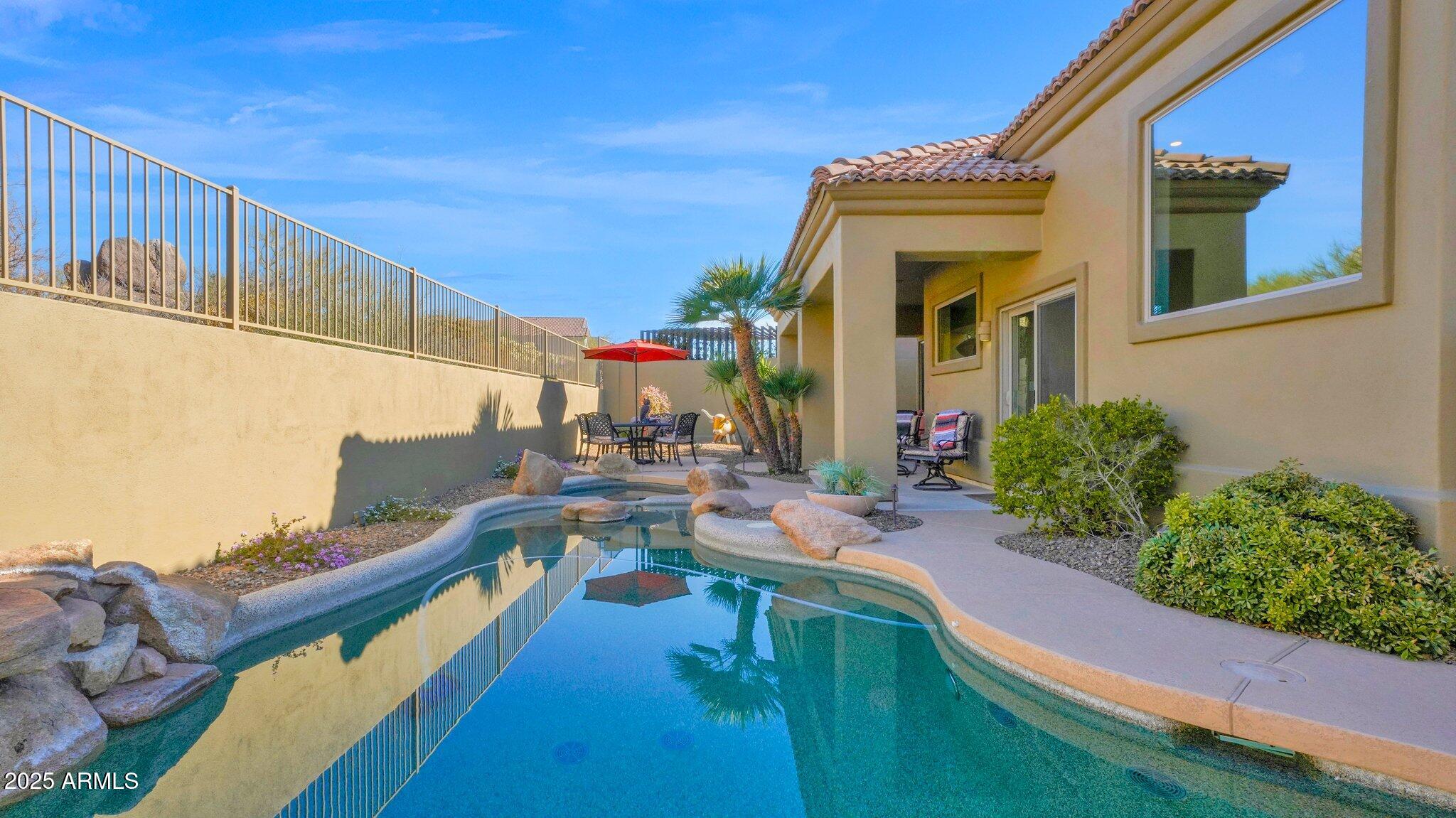 11516 East Ranch Gate Road Scottsdale, AZ 85255 - Photo 13 of 36 a view of a house with pool and chairs