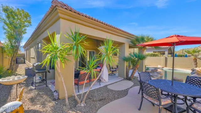 a view of a chairs and table in the patio