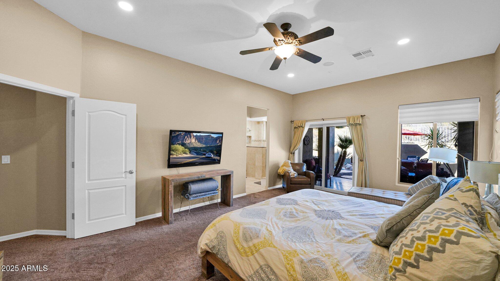 11516 East Ranch Gate Road Scottsdale, AZ 85255 - Photo 19 of 36 a bed room with a bed a television and a chandelier
