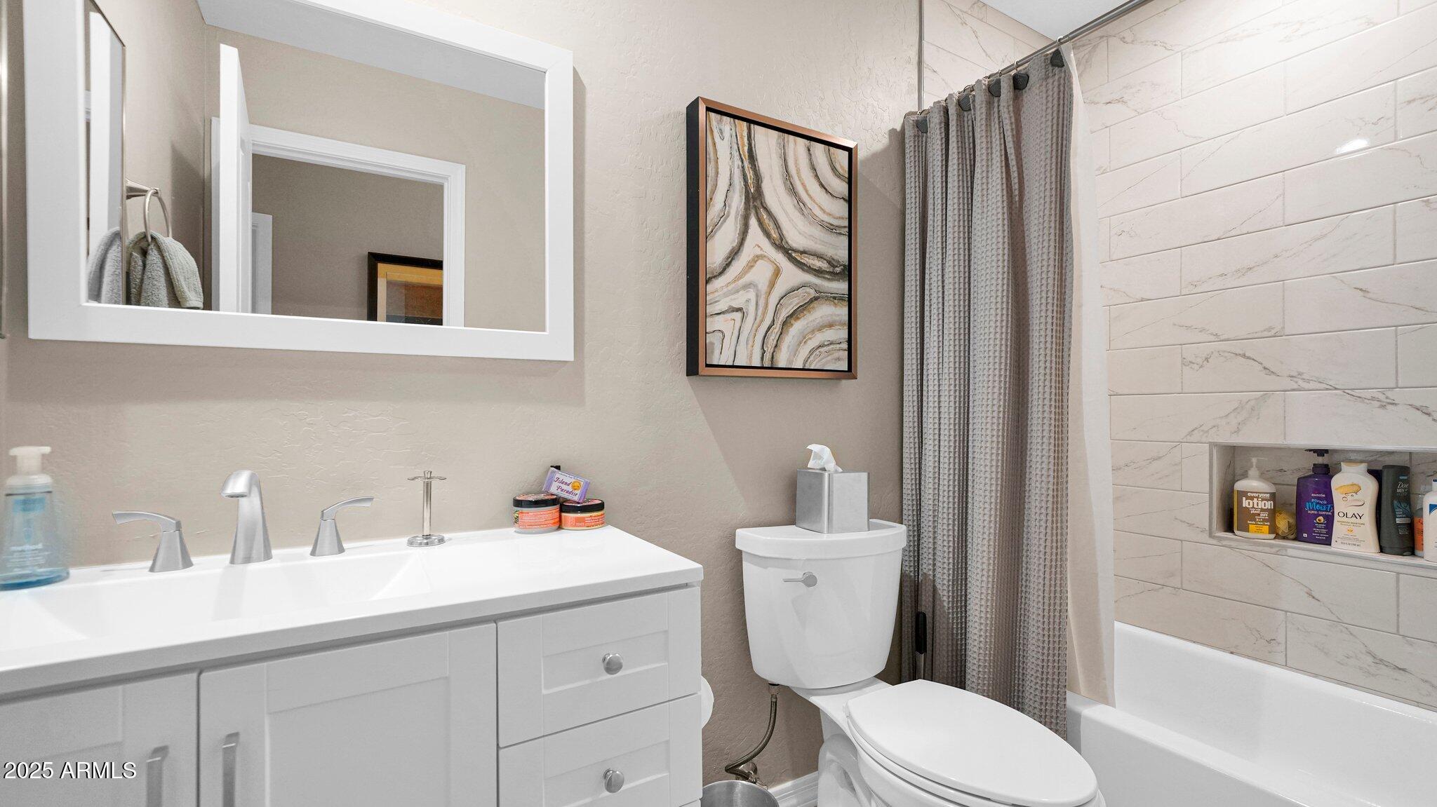 11516 East Ranch Gate Road Scottsdale, AZ 85255 - Photo 24 of 36 a bathroom with a toilet sink and mirror