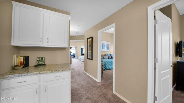 a kitchen with granite countertop a refrigerator and cabinets