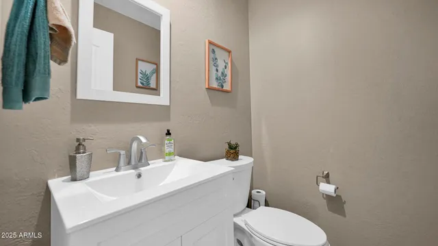 a bathroom with a sink mirror and toilet