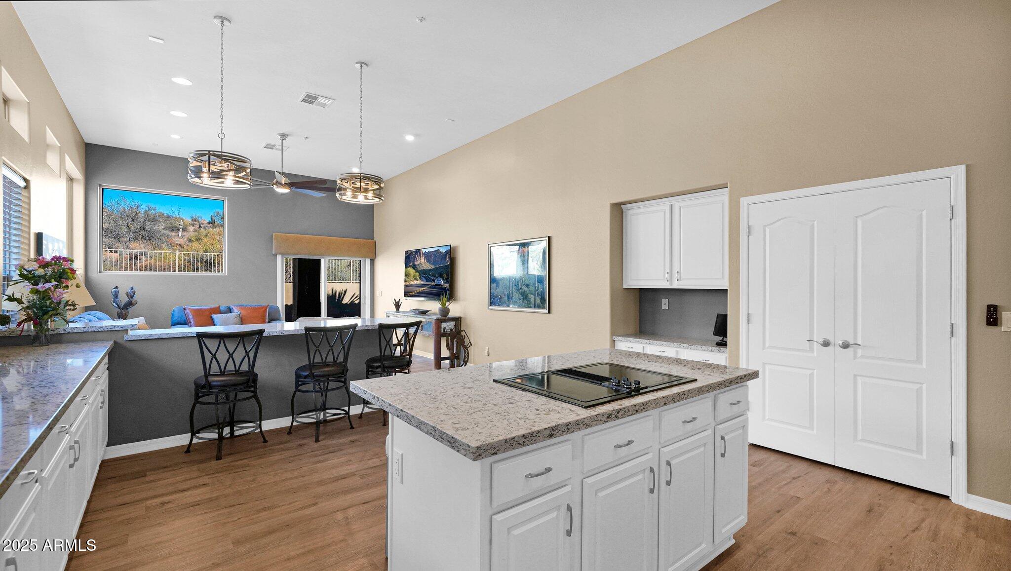11516 East Ranch Gate Road Scottsdale, AZ 85255 - Photo 4 of 36 a kitchen with a sink cabinets and wooden floor
