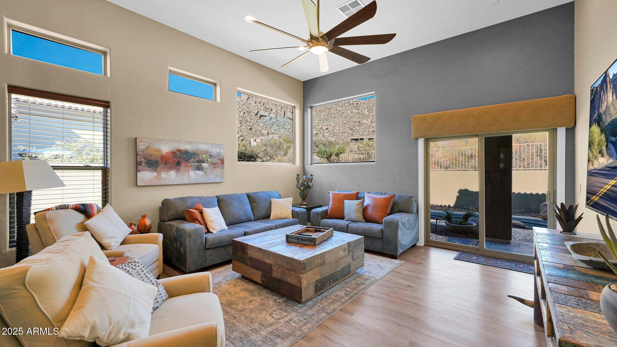 11516 East Ranch Gate Road Scottsdale, AZ 85255 - Photo 8 of 36 a living room with furniture a flat screen tv and a large window