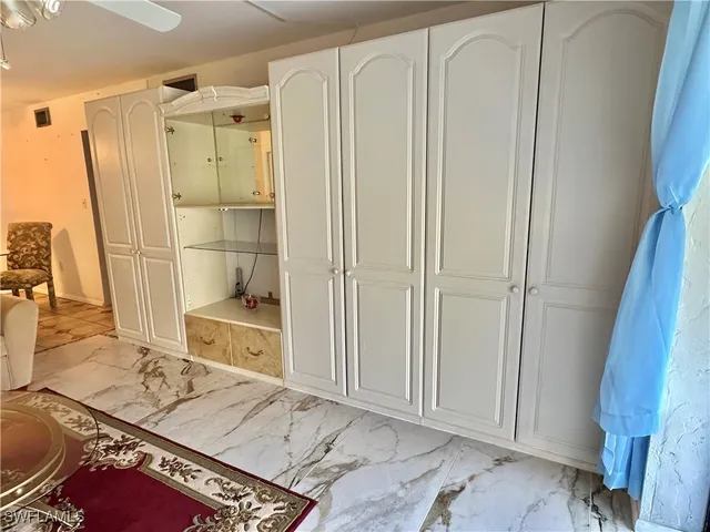 a bathroom with a granite countertop sink a mirror and shower
