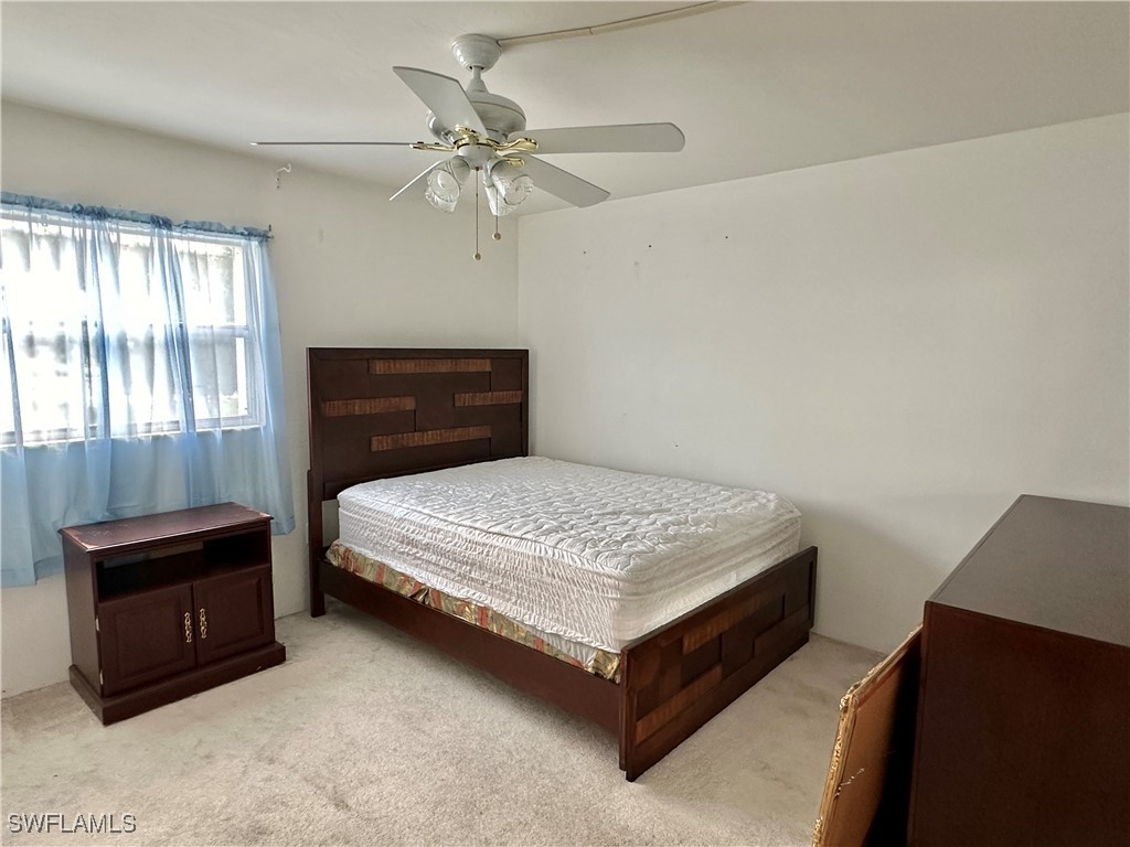 2828 Jackson Street, Unit F7 Fort Myers, FL 33901 - Photo 15 of 49 a bedroom with a bed and window