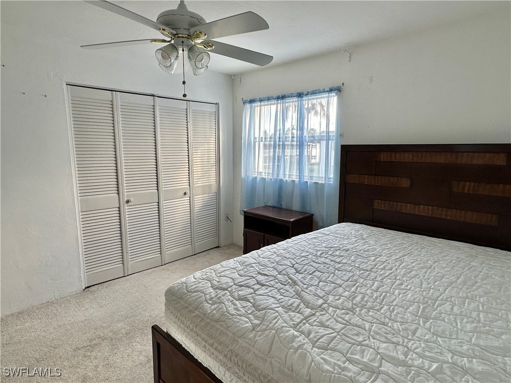 2828 Jackson Street, Unit F7 Fort Myers, FL 33901 - Photo 16 of 49 a bedroom with a bed and a closet