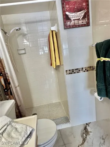 a bathroom with a toilet and shower