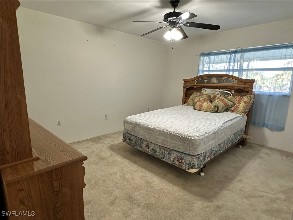 2828 Jackson Street, Unit F7 Fort Myers, FL 33901 - Photo 19 of 49 a bedroom with a bed and window