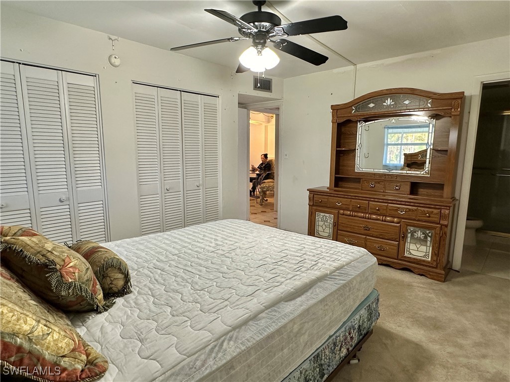 2828 Jackson Street, Unit F7 Fort Myers, FL 33901 - Photo 21 of 49 a bedroom with a bed and a television