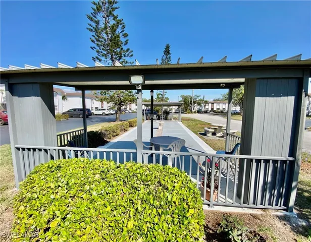 a view of a patio with a table and chairs