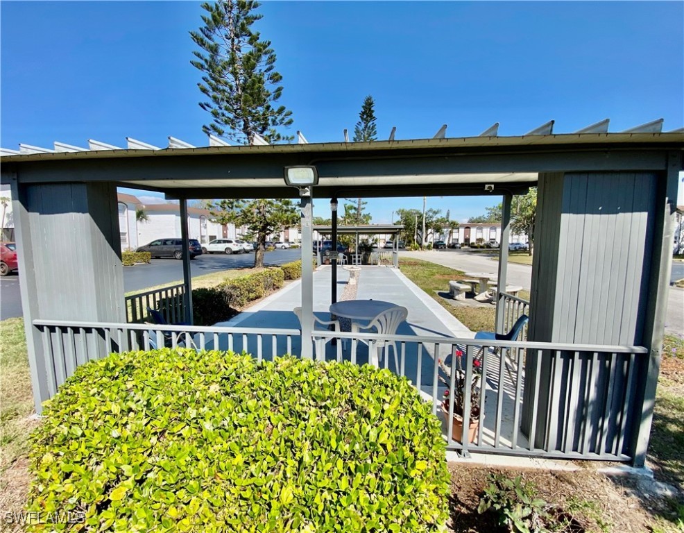 2828 Jackson Street, Unit F7 Fort Myers, FL 33901 - Photo 29 of 49 a view of a porch with wooden floor