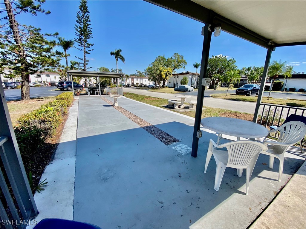 2828 Jackson Street, Unit F7 Fort Myers, FL 33901 - Photo 31 of 49 a view of a patio with a table chairs and a patio