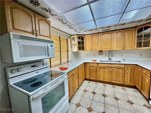a kitchen with a stove a sink and a microwave