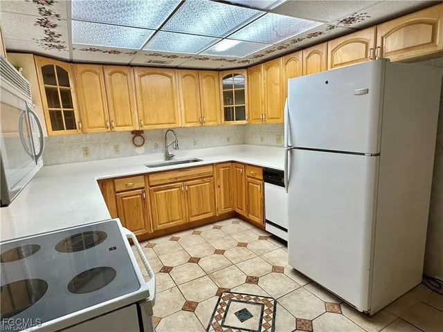 a kitchen with a cabinets and white appliances