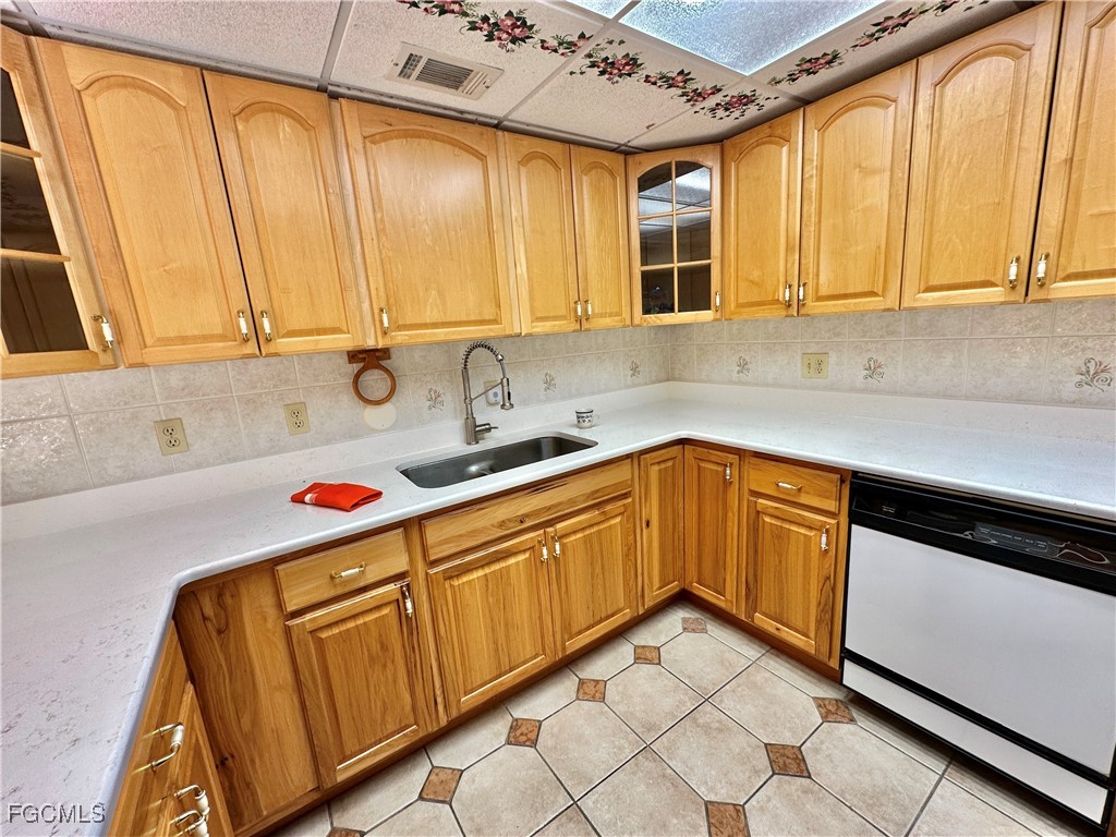 2828 Jackson Street, Unit F7 Fort Myers, FL 33901 - Photo 7 of 49 a kitchen with wooden cabinets and a sink