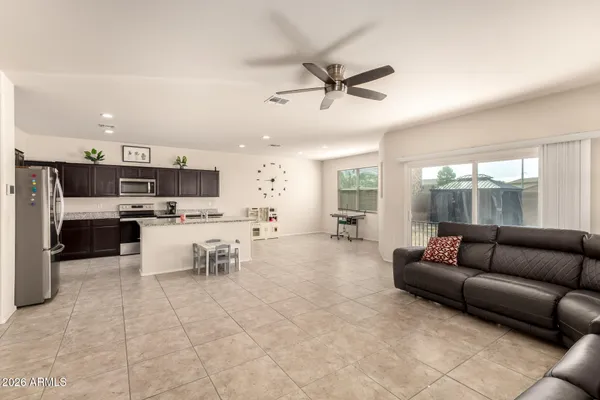 a living room with furniture and kitchen view