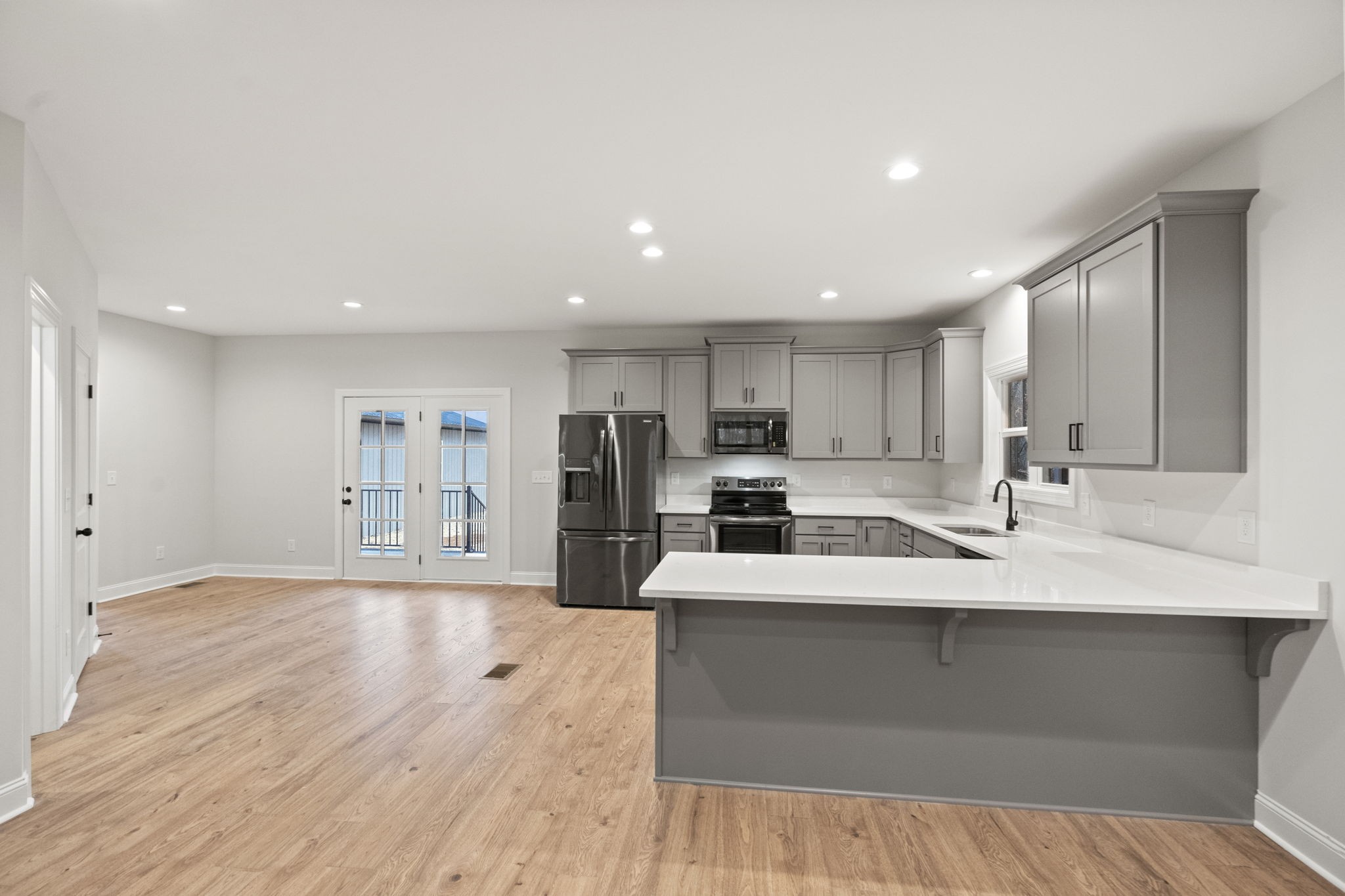 8919 Cedar Grove Road Cross Plains, TN 37049 - Photo 7 of 36 a large white kitchen with wooden floor and a sink