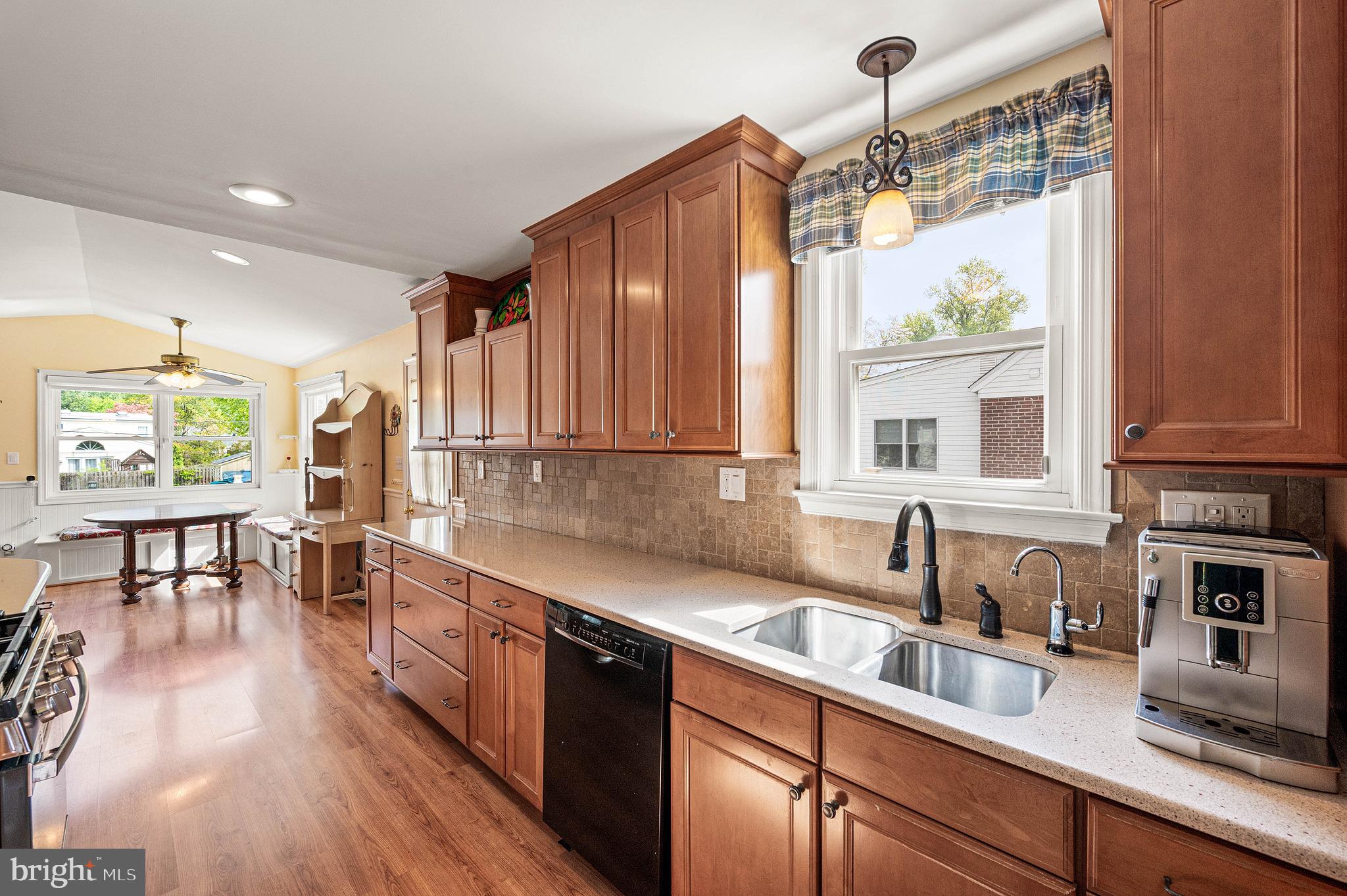 453 Claremont Road Springfield, PA 19064 - Photo 11 of 32 a kitchen with kitchen island granite countertop a sink window and cabinets