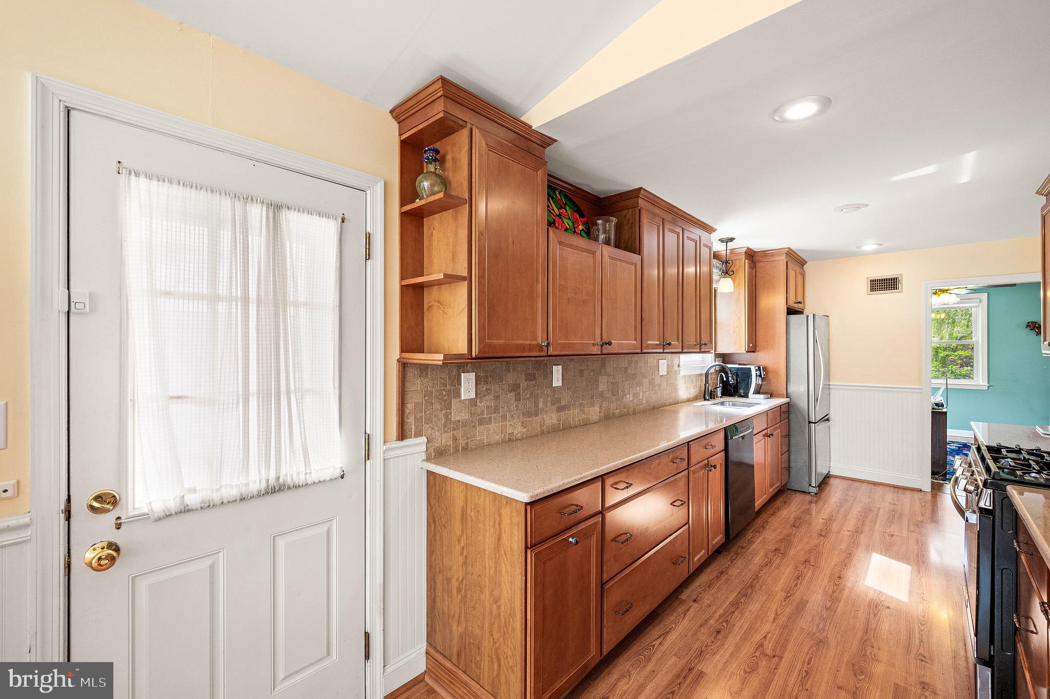 453 Claremont Road Springfield, PA 19064 - Photo 13 of 32 a kitchen with stainless steel appliances granite countertop a stove and a sink