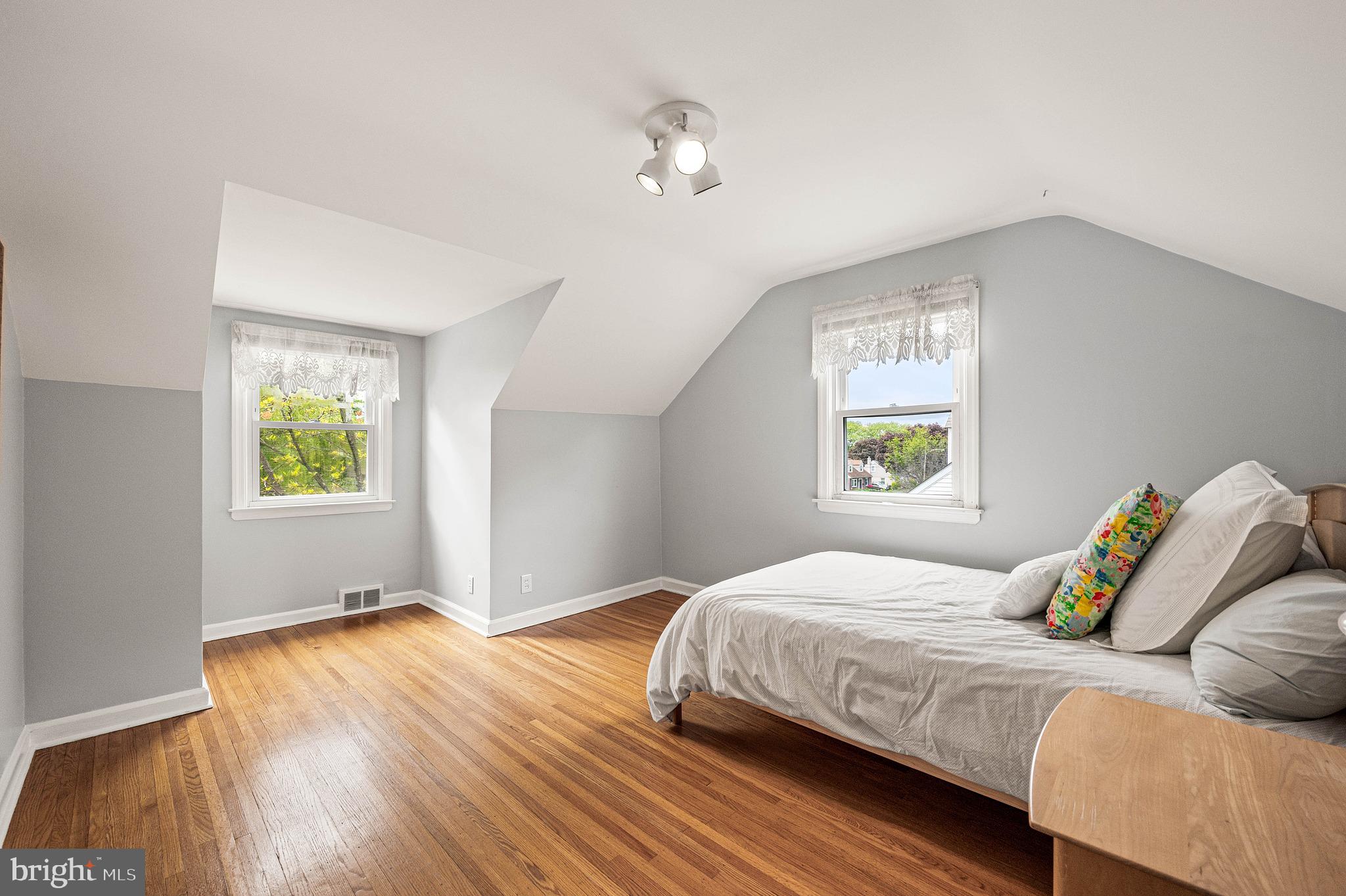 453 Claremont Road Springfield, PA 19064 - Photo 22 of 32 a bedroom with a bed and wooden floor