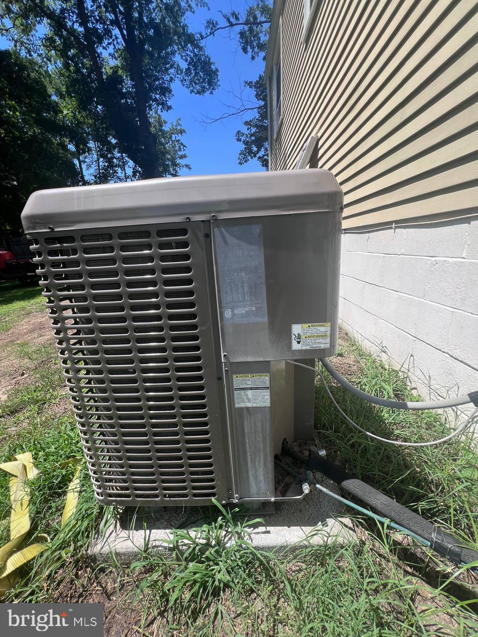 9613 Kendrick Road North Chesterfield, VA 23236 - Photo 9 of 66 Cooling unit nestled in lush greenery.