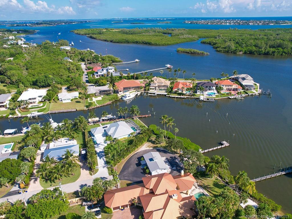 5714 Southeast Horseshoe Point Road Stuart, FL 34997 - Photo 11 of 83 an aerial view of lake and residential houses with outdoor space