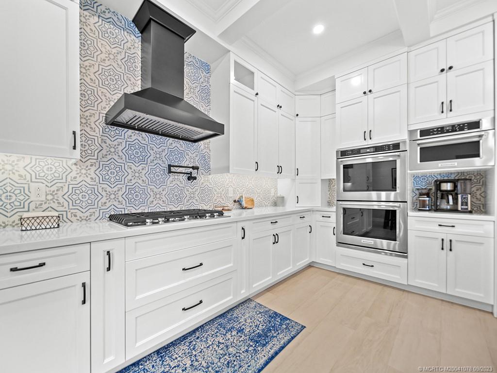 5714 Southeast Horseshoe Point Road Stuart, FL 34997 - Photo 25 of 83 a kitchen with stainless steel appliances a stove a sink and a refrigerator
