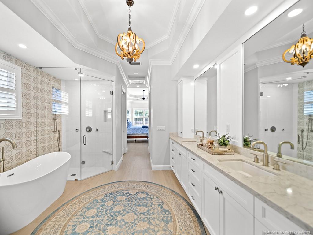 5714 Southeast Horseshoe Point Road Stuart, FL 34997 - Photo 30 of 83 a spacious bathroom with sinks mirror and a bathtub