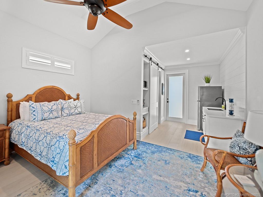 5714 Southeast Horseshoe Point Road Stuart, FL 34997 - Photo 44 of 83 a bedroom with a bed and wooden floor