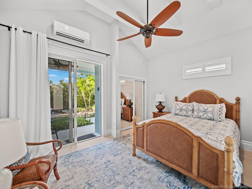 5714 Southeast Horseshoe Point Road Stuart, FL 34997 - Photo 45 of 83 a bedroom with a bed and a dresser next to a window