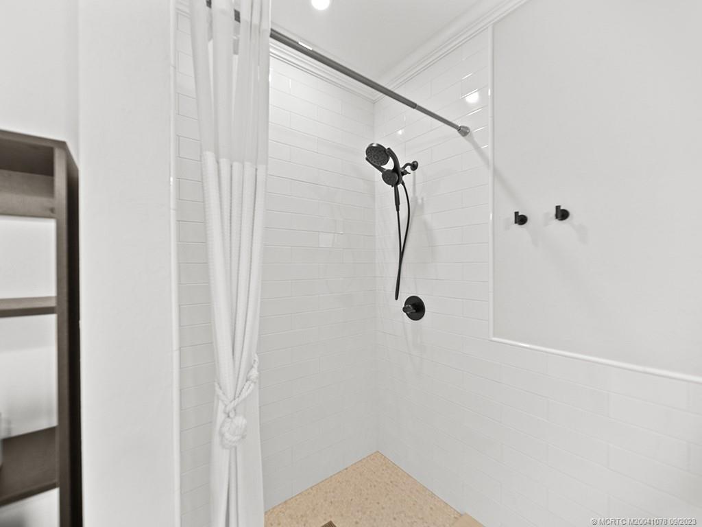 5714 Southeast Horseshoe Point Road Stuart, FL 34997 - Photo 49 of 83 a bathroom with a shower