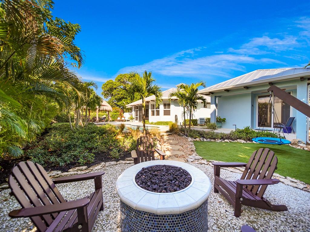 5714 Southeast Horseshoe Point Road Stuart, FL 34997 - Photo 50 of 83 a view of a table and chairs in patio